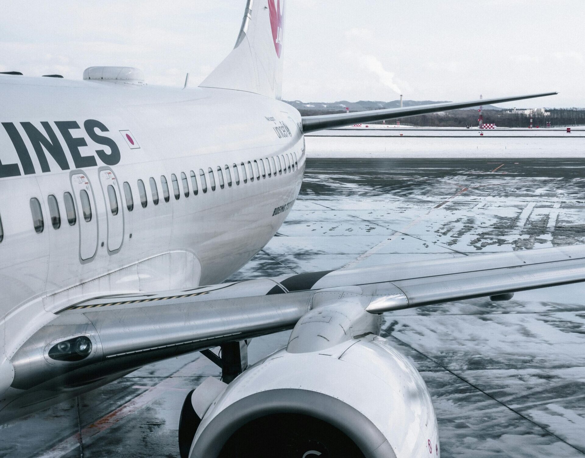 Close-up of an airliner on a wet runway after rain with reflections on the tarmac.
