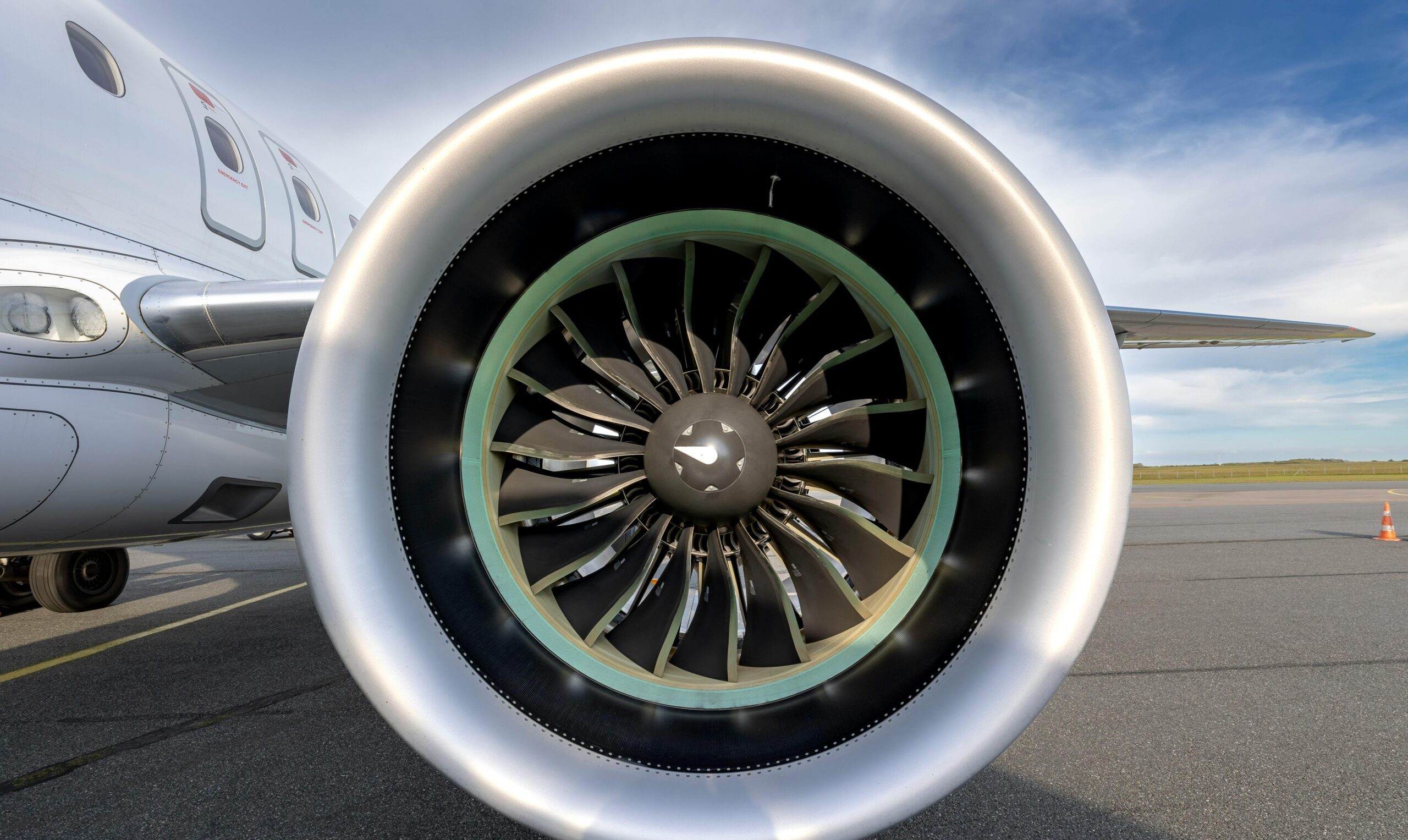 Detailed view of an aircraft jet engine on a sunny day at Sylt airport runway.
